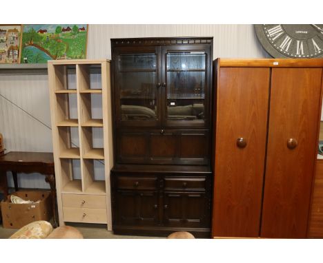 An Ercol side cabinet with its upper section enclosed by glazed doors