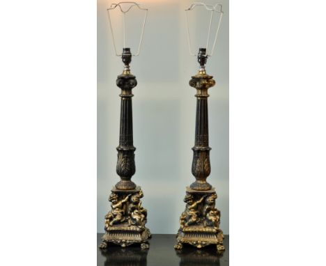 Lighting - a pair of baroque style gilt metal table lamps, each with a Corinthian column supported by four putti and four paw