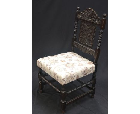 A Victorian Jacobean revival carved oak side chair 