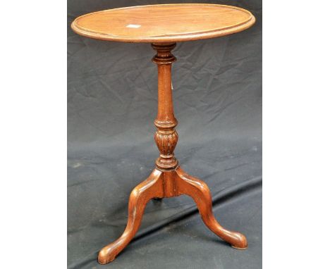 A small oval tripod table