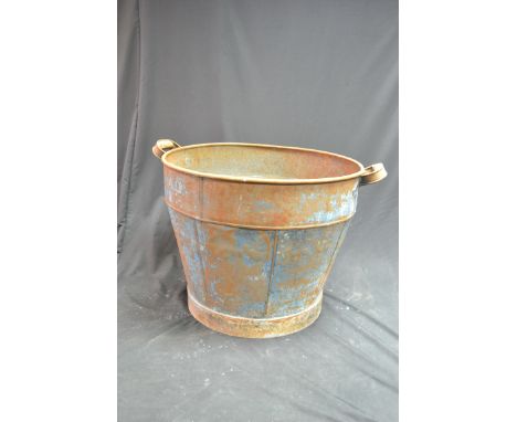 A large galvanised tapering cylindrical three-handled garden trough, 77cm diameter