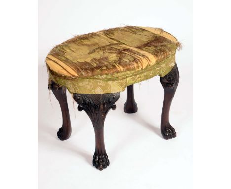 A 19th century Irish mahogany oval stool, stuffed over upholstery, cabriole legs carved with acanthus, lion paw feet, warehou