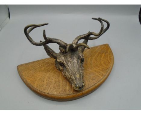 Painted brass stag head on wooden base (hinged like a door knocker)