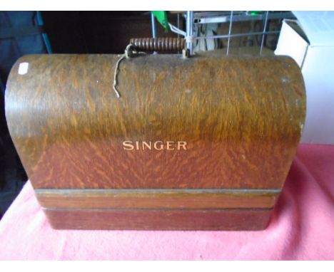 Vintage Singer sewing machine in wooden case with key