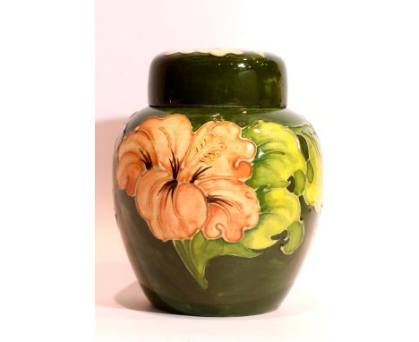 Moorcroft ceramic ginger jar in the Coral Hibiscus pattern, signed to base, H: 15 cm. P&amp;P Group 2 (£18+VAT for the first 