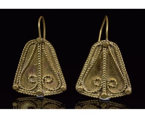 Ca.300-200 BC. An interesting piece of Hellenistic jewelry, a matched pair of apron-shaped earrings each with filigree coils,