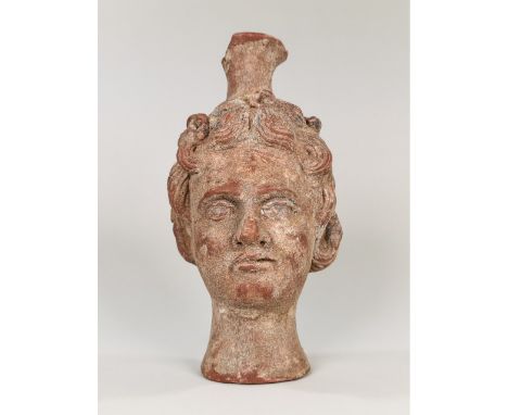 Ca.100-200 AD. A nice Roman terracotta Flask in the Form of Bacchus' Head represented with a youthful look ; nicely detailed 