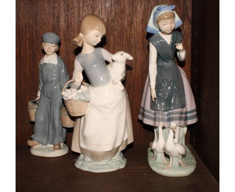 Three Lladro porcelain figures of a Dutch boy carrying milk, a Breton peasant girl with two geese and a girl carrying a lamp