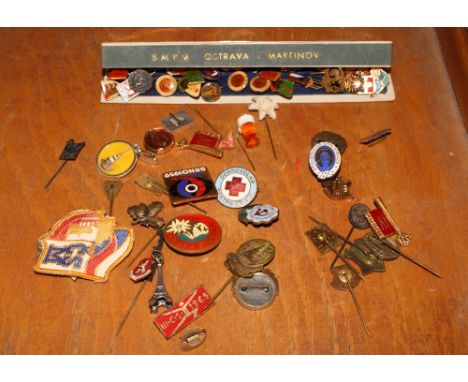 A collection of Czech and other gilt metal and enamel decorated lapel badges, etc