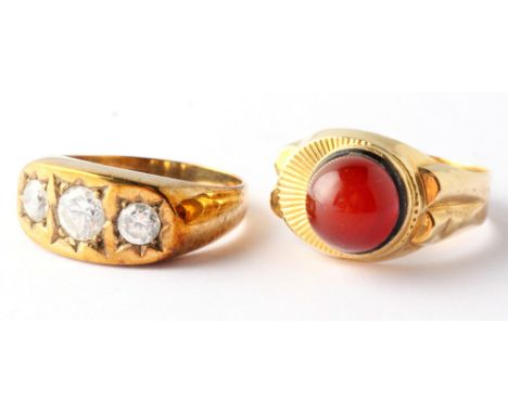 A 9ct gold dress ring set three brilliants and a yellow metal dress ring set red cabochon