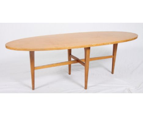 A Gordon Russell light wood oval coffee table, on tapered supports, 48" wide