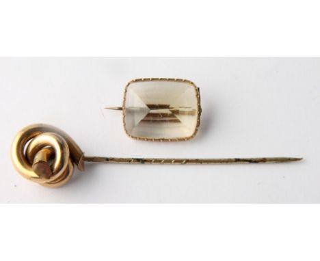 A yellow metal mounted citrine brooch and a yellow metal stick pin