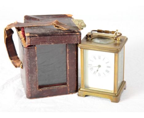 A French carriage timepiece in brass case, white enamel dial, in leather travelling case