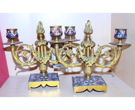 A pair of 19th Century two-branch gilt metal candelabra with champlevé enamel decorated bases and drip pans, 5 1/2" high