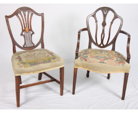 A Georgian mahogany carver dining chair of Hepplewhite design with pierced splat back and serpentine-shaped seat rail, uphols