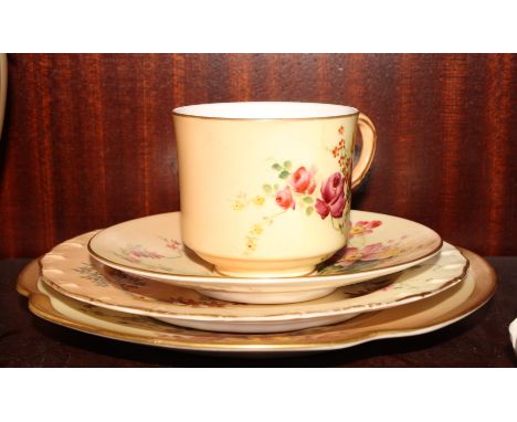 A Royal Worcester floral decorated cup and saucer and two similar Worcester plates