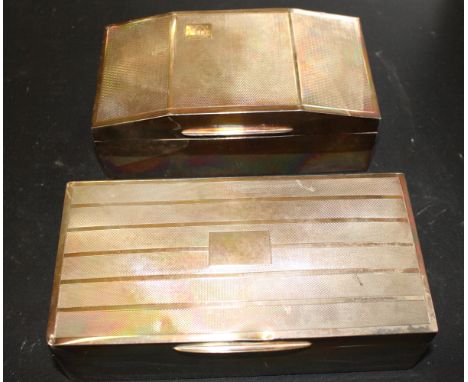 A silver cigarette box with engine turned decoration and another similar