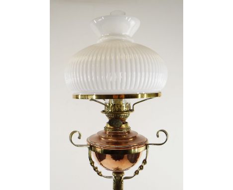 ARTS & CRAFTS BRASS AND COPPER STANDARD OIL LAMP, with foliate decorated tripod base and column, opaque glass shade and funne