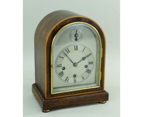 WINTERHALDER & HOFFMEISTER MANTEL CLOCK, mahogany and boxwood strung arched case with strike/silent above the roman dial, 25.