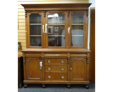 LATE 19TH CENTURY LIGHT OAK CABINET DRESSER, ogee cornice and pollard oak frieze above triple glazed doors on a chest base, f