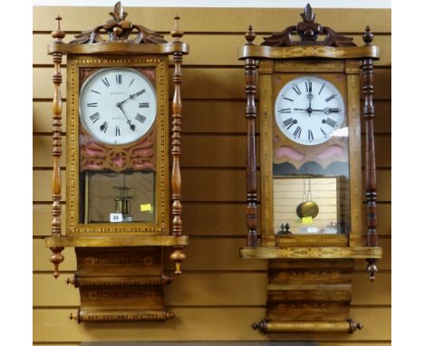TWO AMERICAN WALNUT MARQUETRY DROP DIAL WALL CLOCKS, with 8 inch roman white enamel dials, turned columns and finials, one si