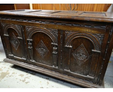 17TH CENTURY-STYLE OAK COFFER, panelled moulded top above arch carved triple panelled front, moulded base and style feet, 105