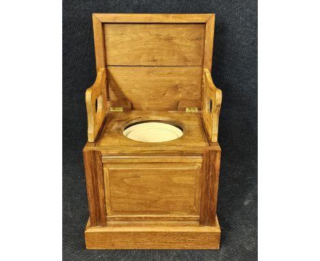 An elm campaign style commode chair with hinged lid. H.84 W.51 D.45cm. 