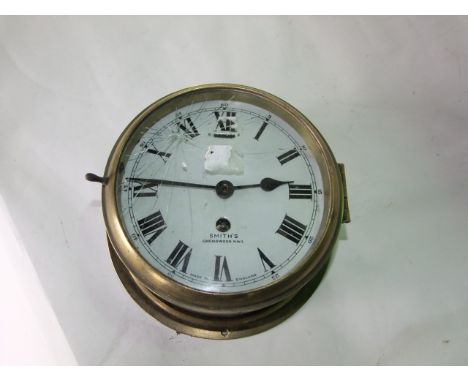 A Smiths marine bulkhead clock with part brass case, enamel dial and eight day timepiece