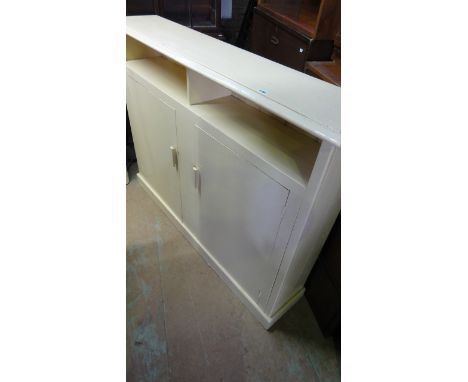 A vintage narrow freestanding painted pine side cupboard, partially enclosed by a pair of doors beneath segmented shelves, 13