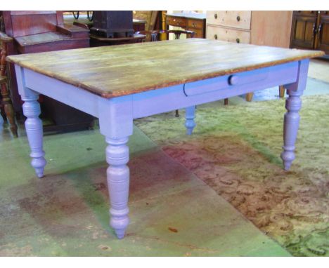 A  vintage pine scrub top kitchen table of rectangular form, the later painted base fitted with a central frieze drawer raise