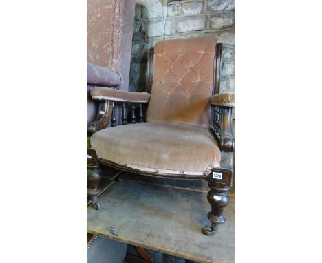 A Victorian drawing room chair with upholstered seat, shaped buttoned back and arm rails with turned spindles and further tur