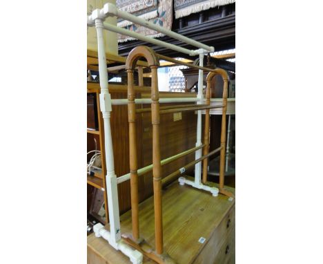 A vintage painted pine free standing towel rail with turned frame, together with one other in stained beech
