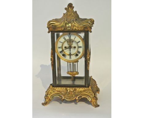 A 19th century cast and gilded brass 4 pane mantle clock, the dial with visible escapement and mercury compensating pendulum,