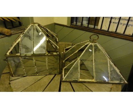 A late 19th/early 20th century cast iron framed pyramid shaped garden cloche/hand light together with one other complete with