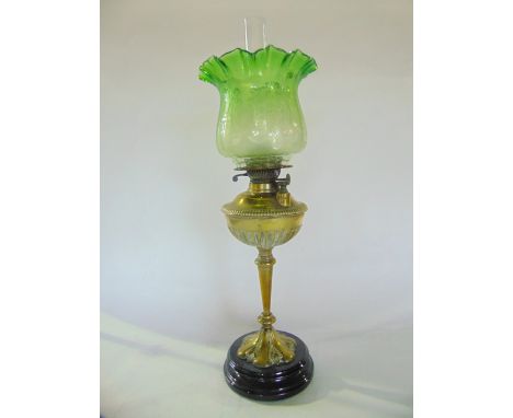 A 19th century brass oil burning lamp with a screw tapped reservoir and British made Duplex burner accommodating a green tint