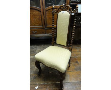 A Victorian walnut side chair with carved bobbin moulded and other detail, upholstered seat and back and raised on cabriole f