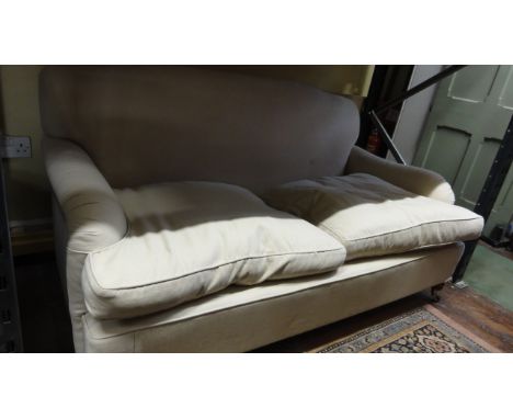 A good quality contemporary two/three seat sofa in the Howard style, with shaped outline, cream coloured upholstery, loose fe