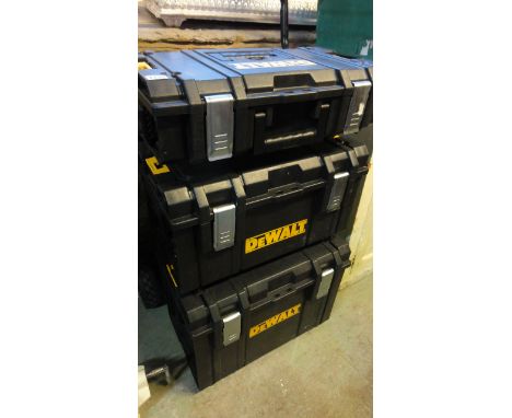 A Dewalt tough system trolley with three moulded plastic removable tool boxes
