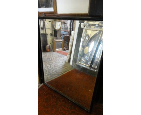A vintage, probably 19th century, wall mirror of rectangular form with bevelled edge plate within a simple moulded ebonised p