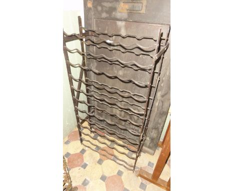 An ironwork wine bottle rack to hold 72 bottles