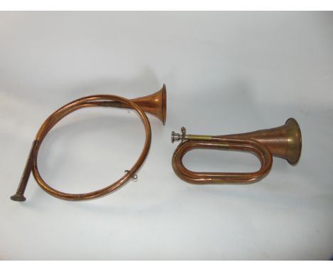 A copper military bugle with applied stamp CSA together with a further copper horn (2)