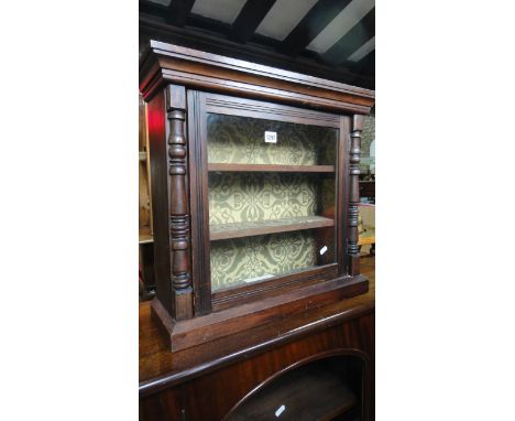 A small vintage wall mounted/table top display cabinet, the stained pine frame enclosed by a glazed panelled door revealing a