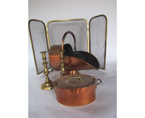 Metal wares to include a copper coal hod, a folding brass fireguard, a lidded copper cooking pan, a pair of brass candlestick