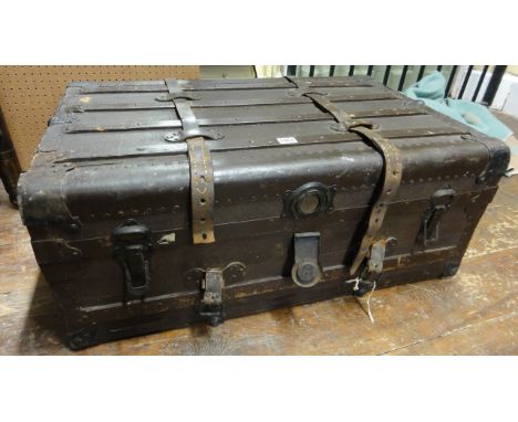 A vintage fibre/timber lathe steel banded travelling trunk with stitched leather carrying handles and removable tray to inter