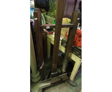 A vintage freestanding and adjustable artists easel in stained beech with 'A' framed shaped supports and castors