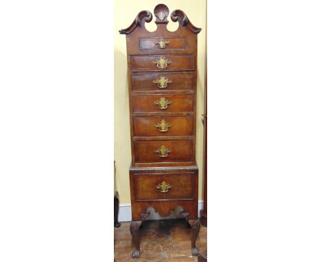 A good quality Georgian style walnut veneered tallboy, the upper section with scrolled acanthus architectural broken arch ped
