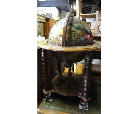 A contemporary drinks cabinet in the form of a reproduction globe and stand, with spiral twist columns