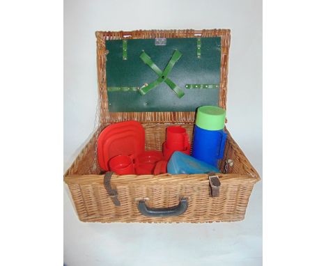 An Antler brand wicker picnic hamper containing a quantity of plastic picnic accessories