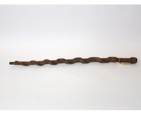 A rustic carved timber stick detailed with a clambering serpent, eastern in style, believed to be an article of First World W