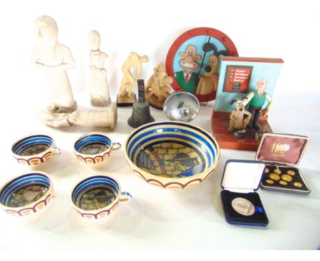 A miscellaneous collection to include souvenir replicas of ancient eastern sculpture, a Wallace and Gromit branded novelty al